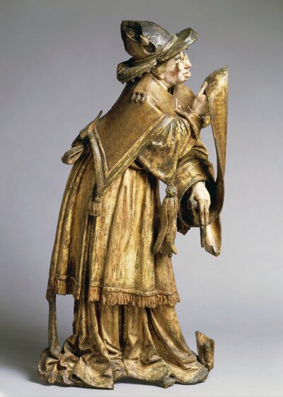 Lesender Prophet mit Brille und Schriftband.