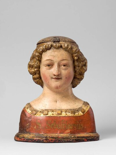 Büste eines jungen Mannes aus Holz. Auf seiner Brust steht: S. Sebastianus.
