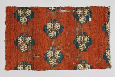 Gewebter Stoff mit einem Muster aus regelmäßig darauf verteilten Wappen