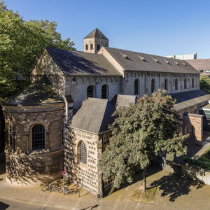 Blick auf den Chor der romanischen Museumskirche St. Cäcilien bei sommerlichem Wetter von der Straße aus gesehen.